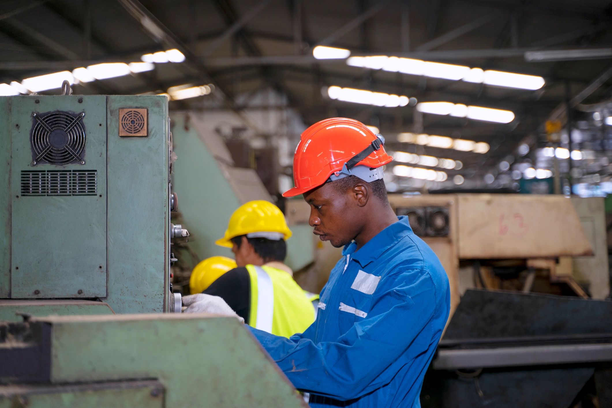 Industrial engineering professional working at machinery in a factory